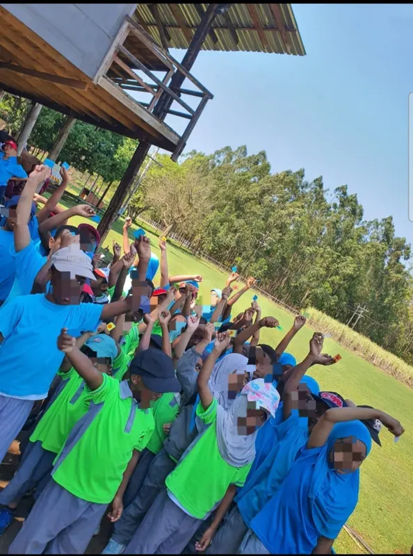 Learners in uniform exercising outdoors at assembly