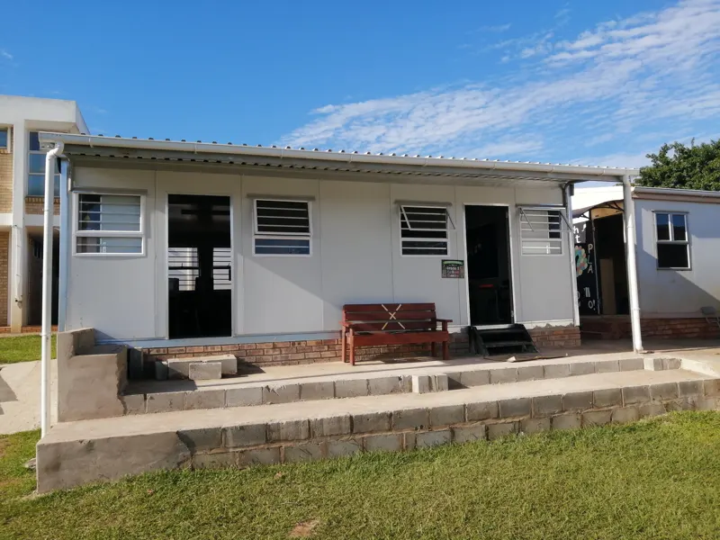 Single-storey prefab classroom block at the current school
