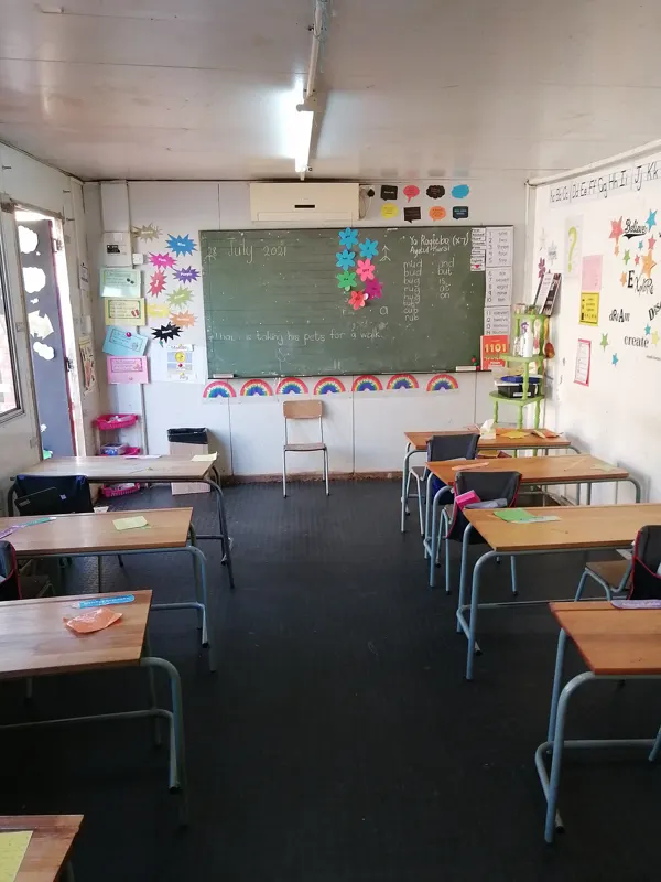 A tidy classroom with desks and a chalkboard