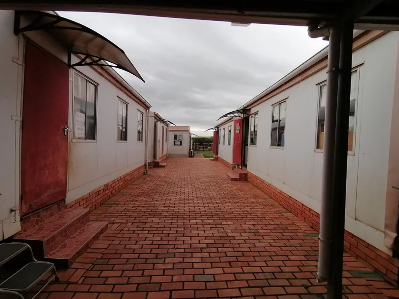 Brick walkway between the prefab classrooms