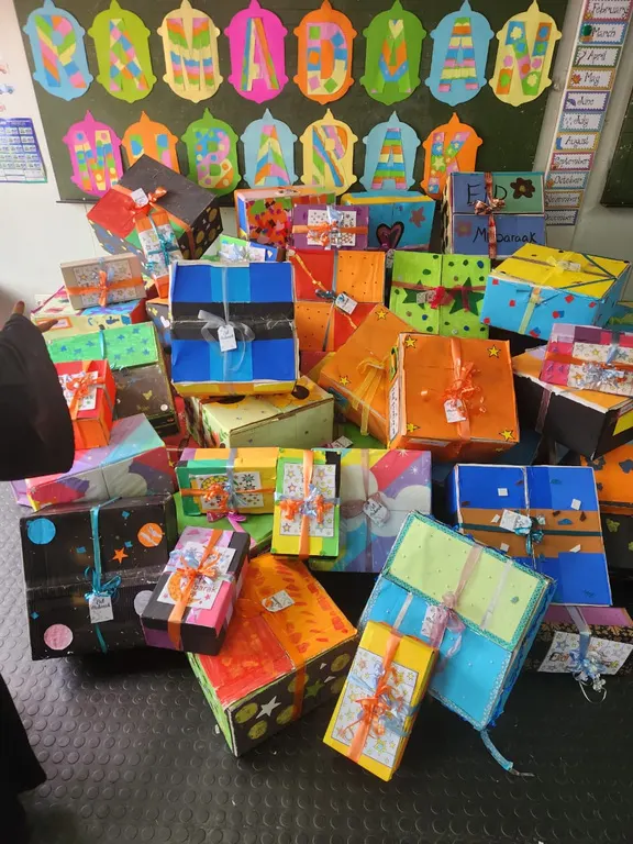 Stack of colourfully wrapped gift boxes made by learners