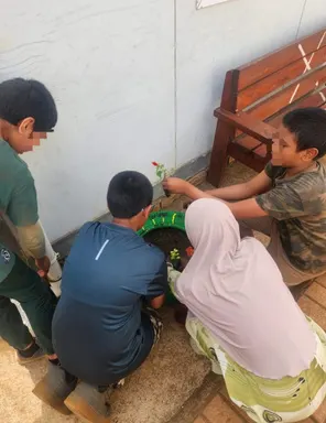 Learners planting a tree together