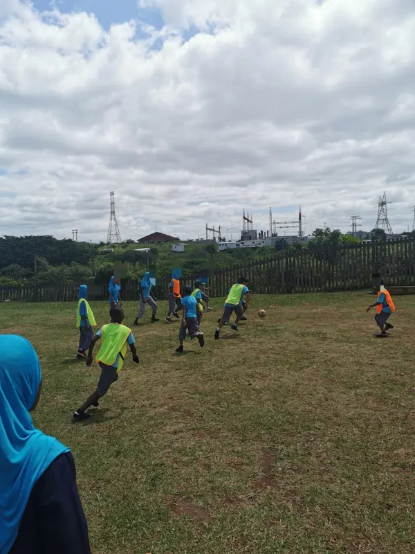 Learners playing soccer on the school field